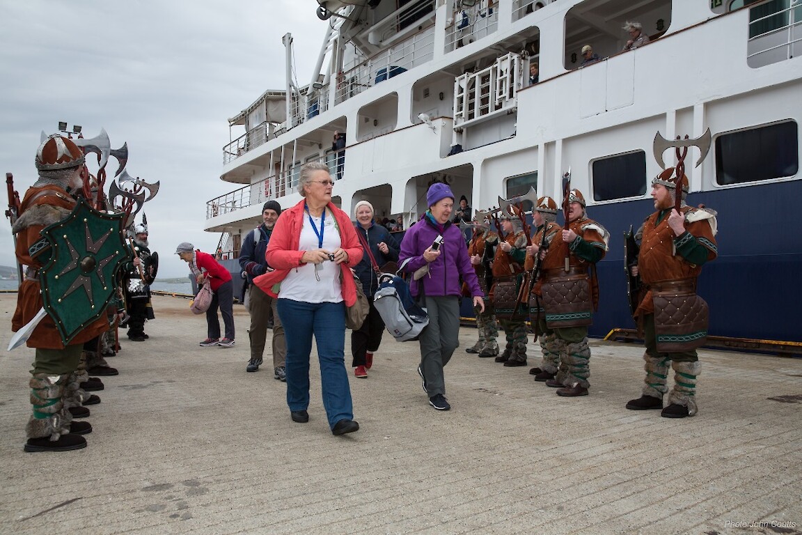 Passengers on Island Sky are treated to a Viking welcome at Lerwick. Credit: John Coutts.