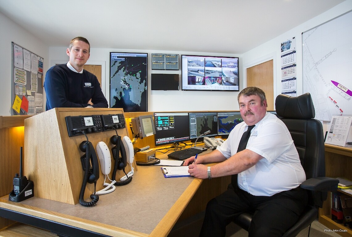 Lerwick Harbour’s port control room and the newly installed Vessel Monitoring System, with Deputy Harbourmaster Alexander Simpson (left) and Port Controller Douglas Garrick (right). Credit: John Coutts