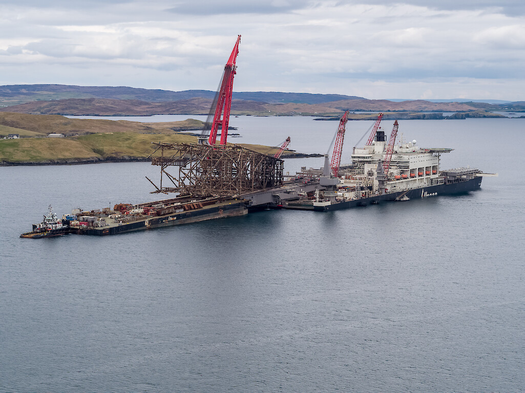 Transfer of jacket structure from "Pioneering Spirit" to "Iron Lady" in progress in deep-water Dales Voe. © Rory Gillies/Shetland Flyer Aerial Media.
