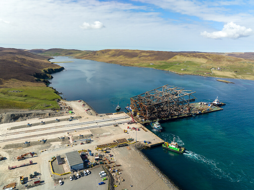 "Iron Lady" barge alongside Dales Voe quay with jacket structure for load-in. © Rory Gillies/Shetland Flyer Aerial Media.